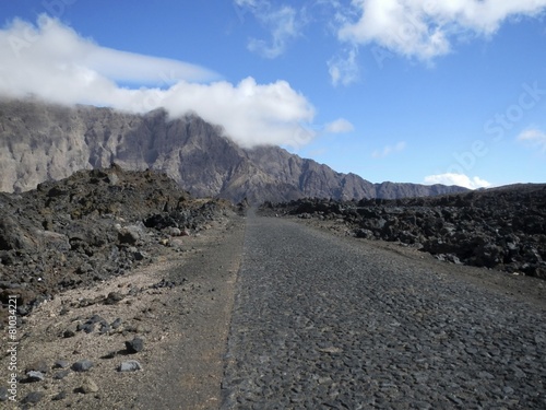 Paved road through black lava field