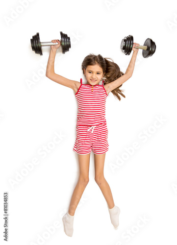 Isolated shot of cute smiling girl lifting up two bug dumbbells
