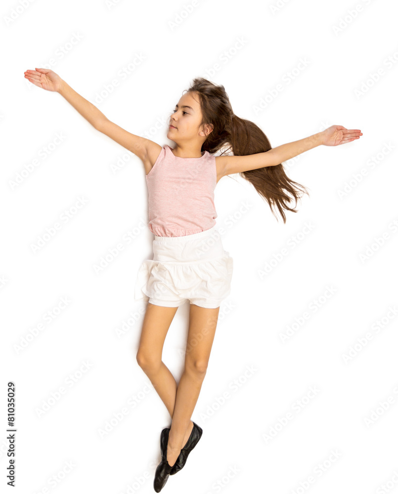 Isolated photo of cute smiling girl in skirt doing ballet pas Isolated photo of cute smiling girl in skirt doing ballet pas