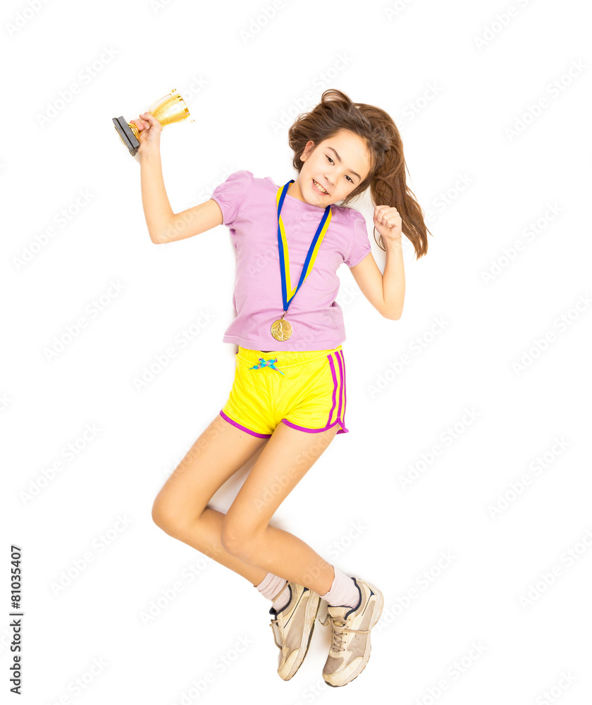 Isolated shot of happy girl jumping with trophy cup and gold med Isolated shot of happy girl jumping with trophy cup and gold med