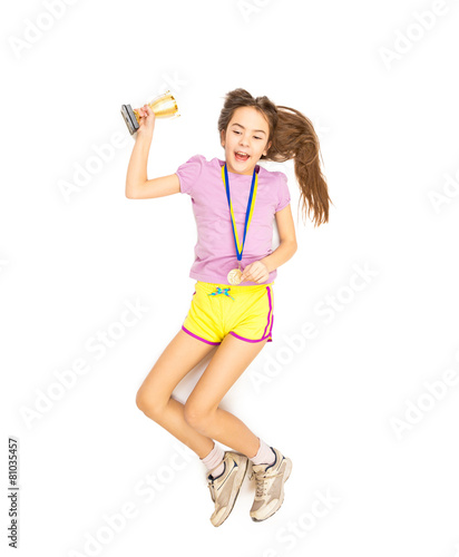 cheering girl jumping high with gold medal and cup