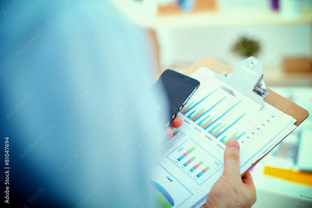 Casual businessman using mobile phone at modern stylish office Casual businessman using mobile phone at modern stylish office