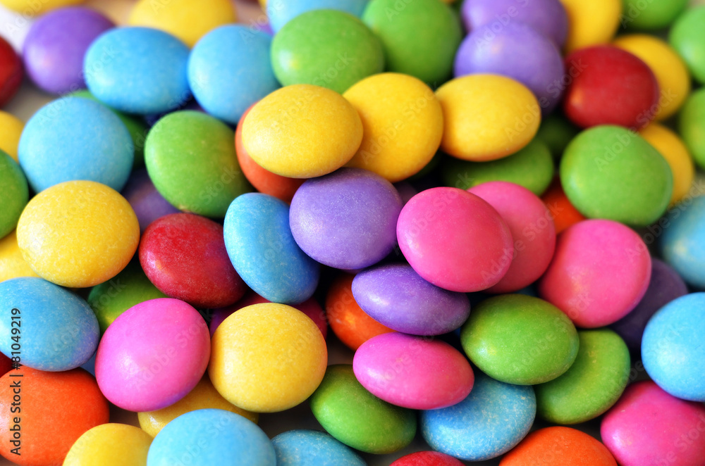 Macro detail of pile of colored smarties Macro detail of pile of colored smarties