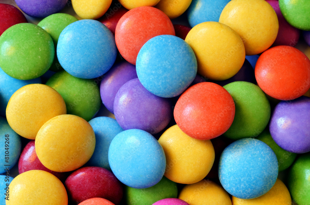Macro detail of pile of colored smarties Macro detail of pile of colored smarties