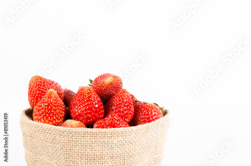 Group of strawberries in sack bag isolated on white background