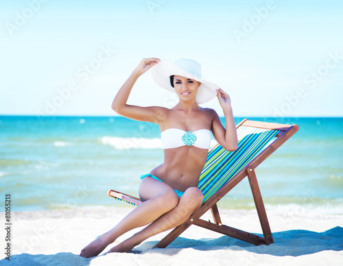 Gorgeous and beautiful young girl relaxing on a summer beach