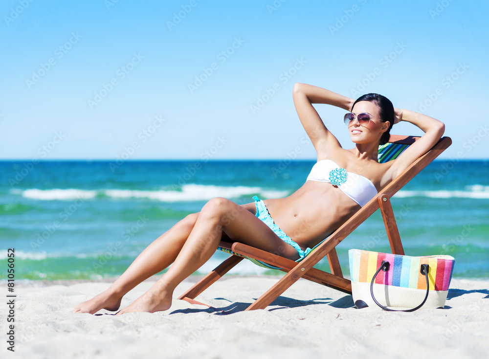 Young, beautiful and sexy woman relaxing on a summer beach Young, beautiful and sexy woman relaxing on a summer beach