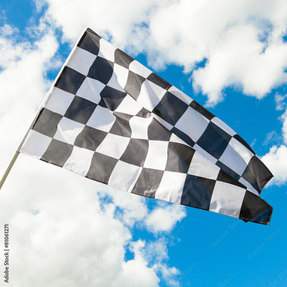 Neat checkered flag waving in the wind - clouds on background