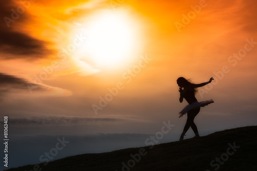 Ballerina silhouette  dancing alone in nature in the mountains a