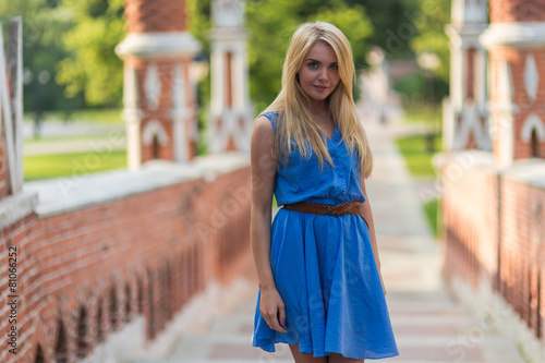 Girl in blue dress enjoying summer day