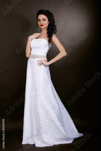 bride in white wedding dress on a dark background