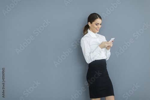 Young woman by the wall