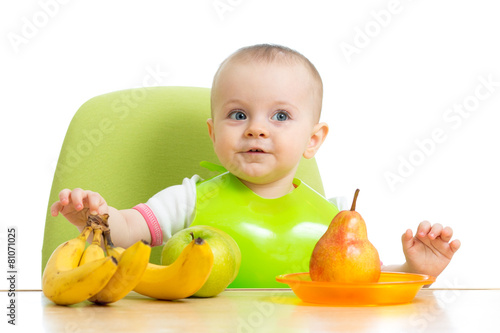 baby sitting at table with ...