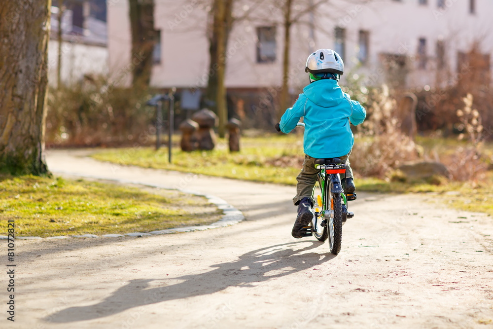 Little preschool kid boy riding with his first green bike Little preschool kid boy riding with his first green bike