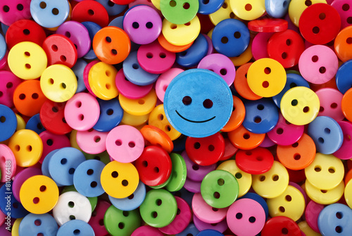 Colorful buttons pile multicolor only one is smiling