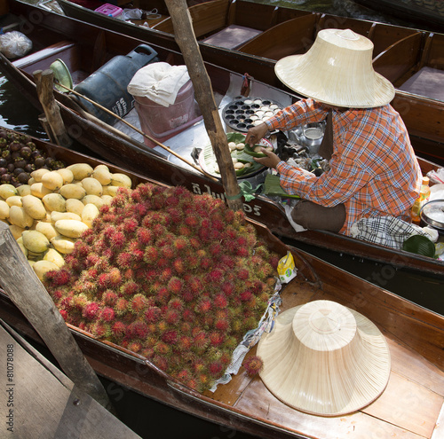 Tableau sur toile Female vendor selling fruit from her boat Thailand