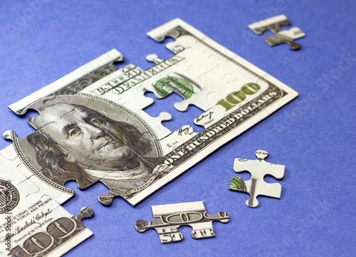 Dollars puzzle. Concept of finance and savings