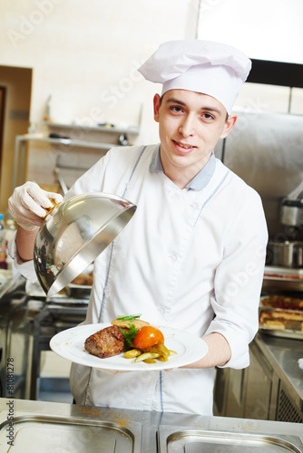 cook chef with food in kitchen