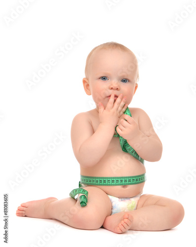 Infant child baby toddler sitting playing with tape measure meas