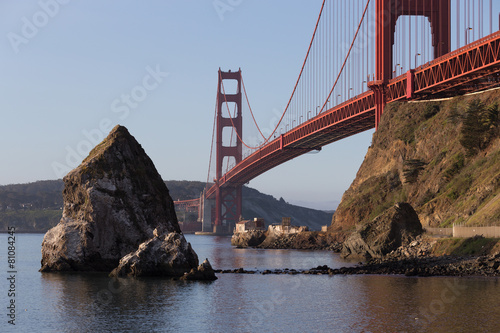 Old lighthouse and fog station under Golden Gate bridge in sunri