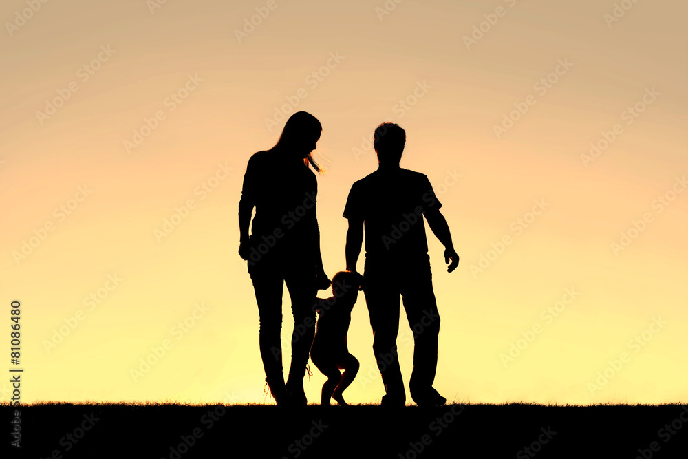 Silhouette of Family of Three People Walking at Sunset Silhouette of Family of Three People Walking at Sunset
