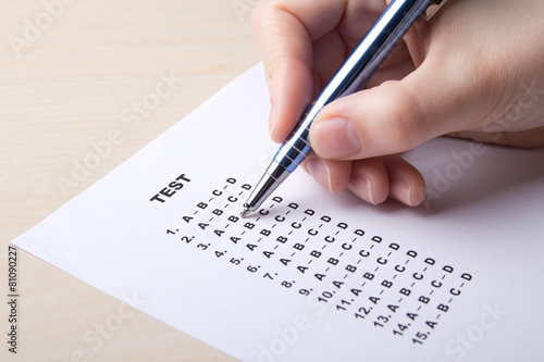 woman filling test sheet with answers