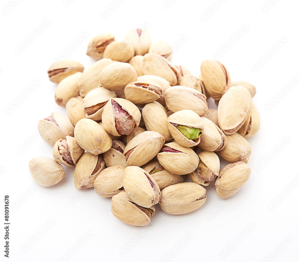 Heap of pistachios nuts isolated on the white Heap of pistachios nuts isolated on the white