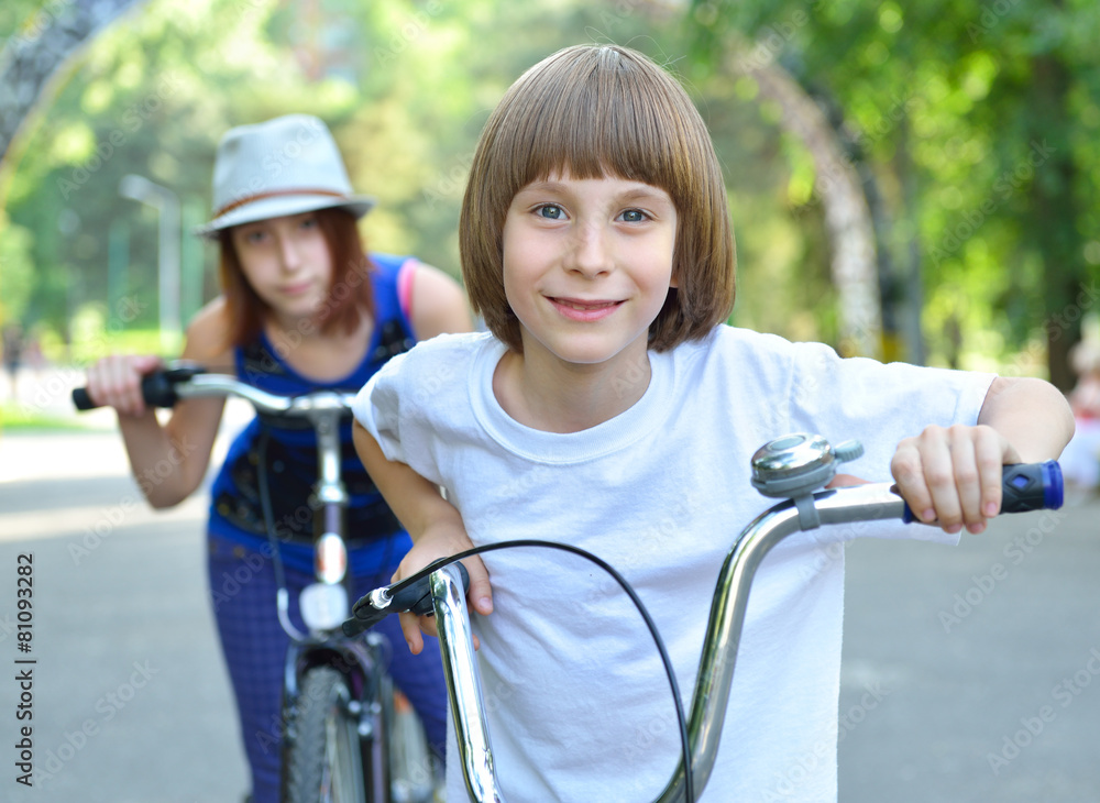 Obraz premium Two children with bicycles bike in park. Childhood, happiness, a