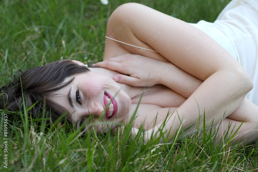 Smiling woman relaxing on the lawn Smiling woman relaxing on the lawn