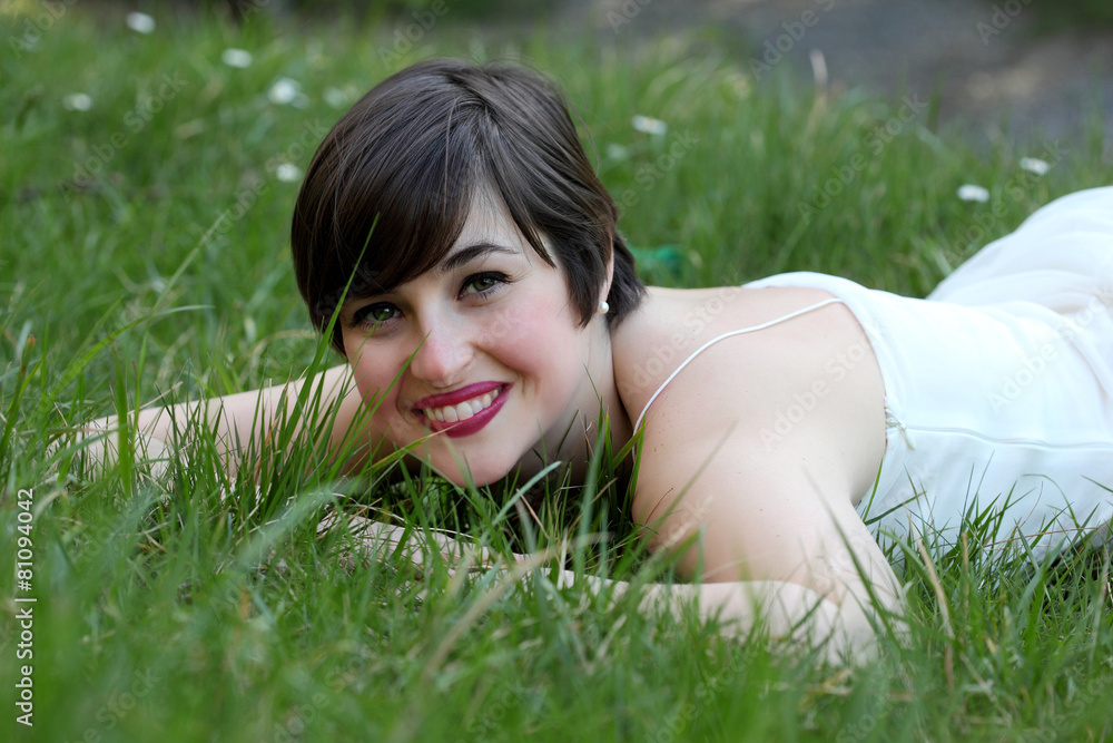 Smiling woman relaxing on the lawn Smiling woman relaxing on the lawn
