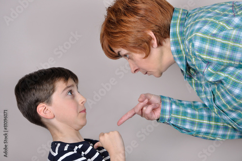 Woman scolding a scared young boy