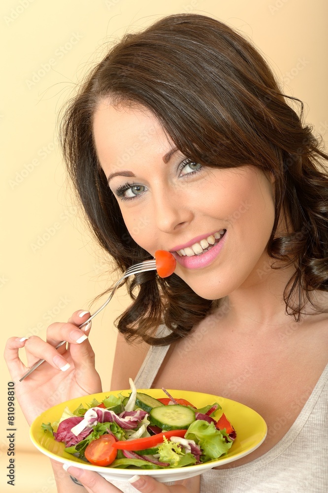 Beautiful Young Woman Looking at the Camera Eating a Salad Beautiful Young Woman Looking at the Camera Eating a Salad
