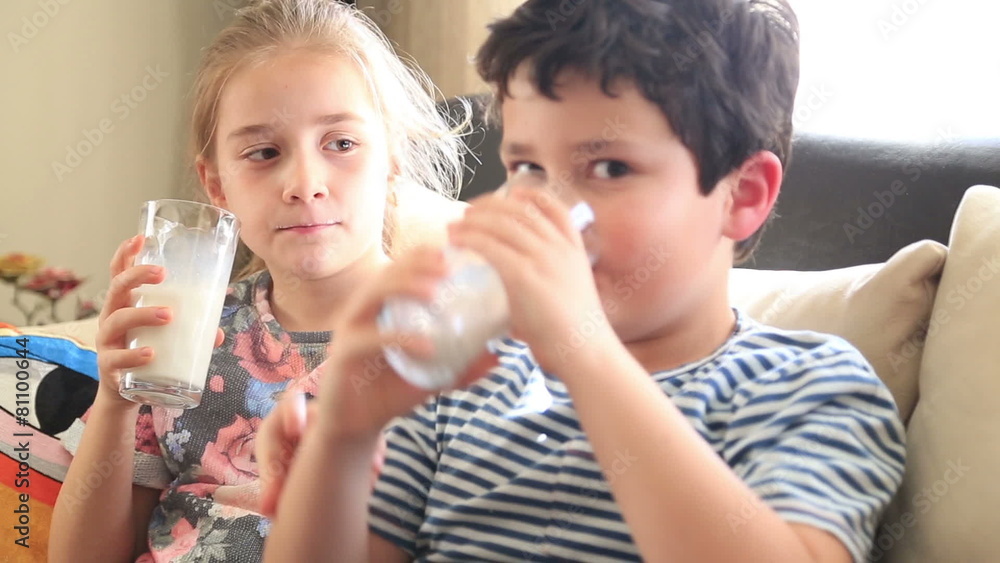 Happy little boy and girl drinking a glass of milk Happy little boy and girl drinking a glass of milk