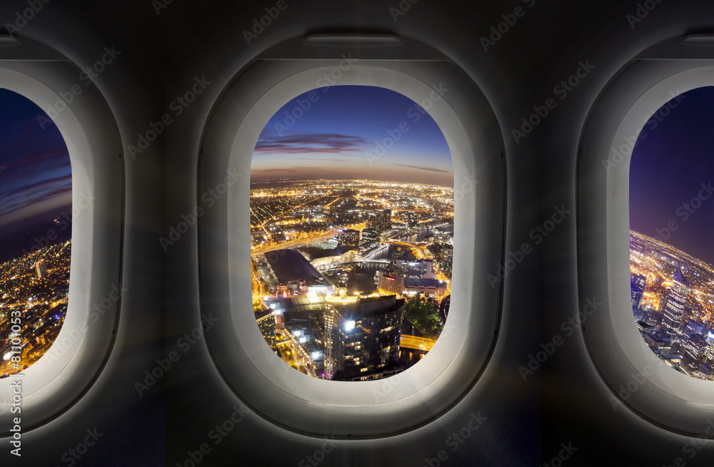 City at night through airplane window City at night through airplane window