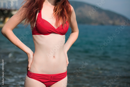 body of the girl in a bathing suit near the sea