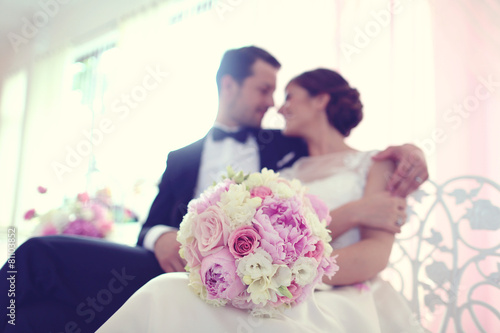 Bride and groom surrounded by flowers