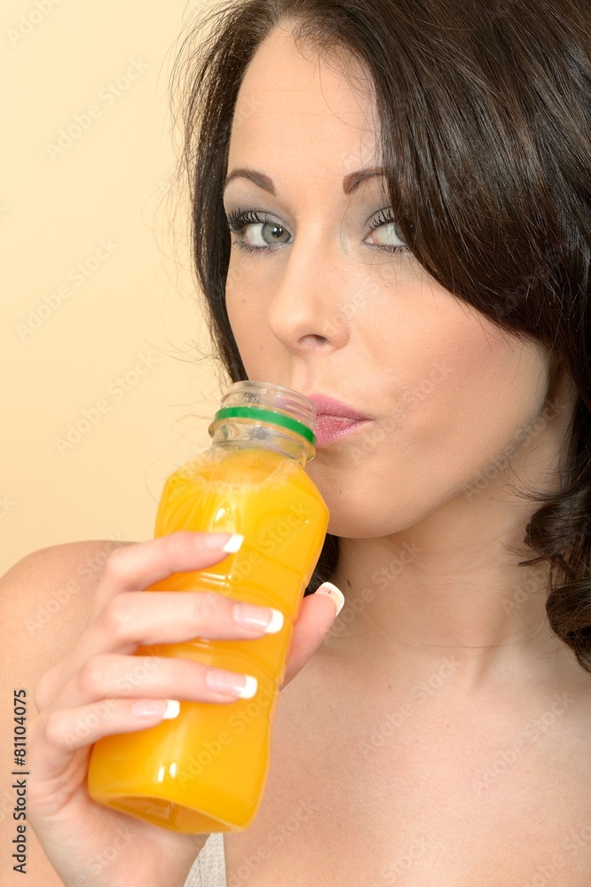 Beautiful Young Woman Holding a Bottle and Drinking Juice Beautiful Young Woman Holding a Bottle and Drinking Juice