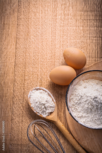 vertical aerial view organized copyspace eggs flour in bowl spoo