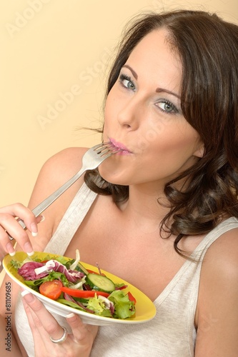 Attractive Beautiful Young Woman Looking at the Camera Eating a