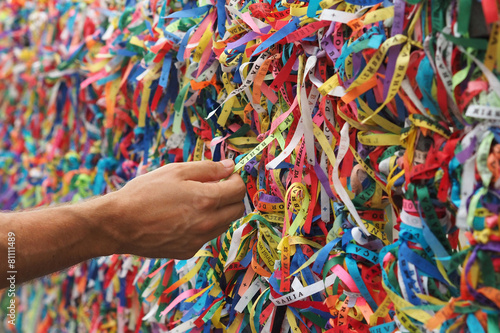 Hand Touching Colorful Bonfim Ribbons in Salvador, Bahia, Brazil photo