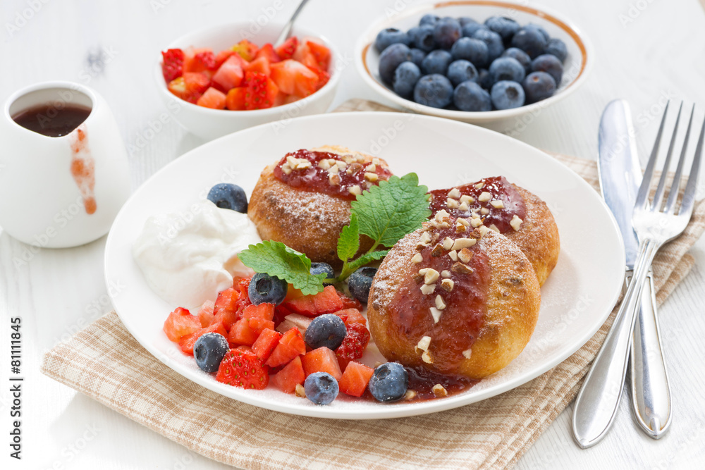 sweet cheese pancakes with fresh berries and cream, close-up sweet cheese pancakes with fresh berries and cream, close-up