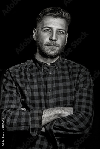 Young man on dark background, dramatical lowkey portrait
