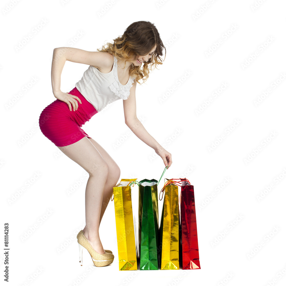Full portrait of smiling young blonde girl with colorful shoppin Full portrait of smiling young blonde girl with colorful shoppin