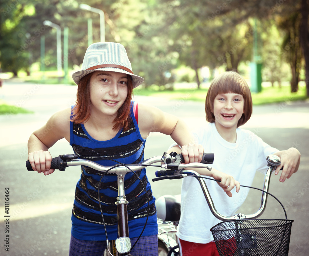 Obraz premium Two children with bicycles bike in park. Childhood, happiness, a