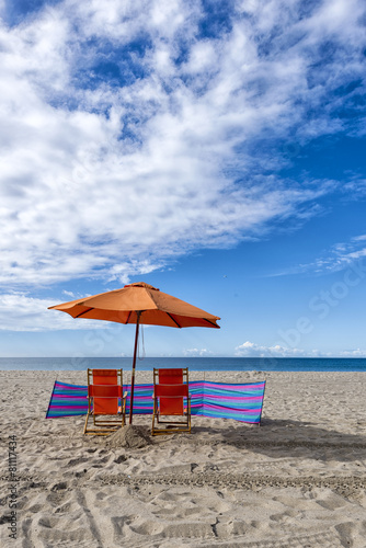 Lounge Chairs and Umbrella at the Beach © senai aksoy