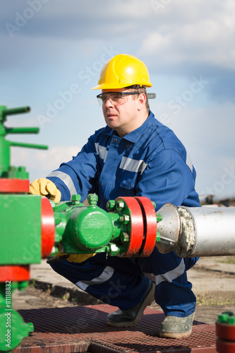 Worker on the oil field. Refinery, oil and gas