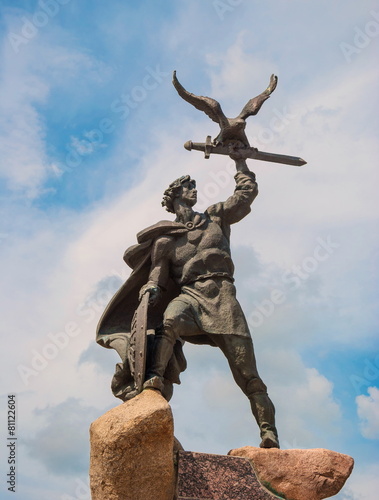 Sculpture Old Russian warrior who holds shield, sword and  eagle