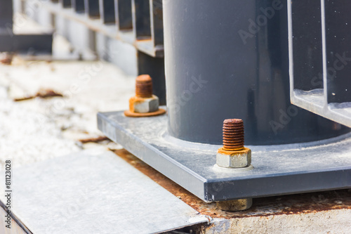 Dark metal column with bolts