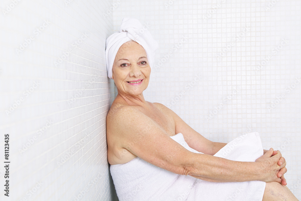 Elderly woman sitting in relaxation room in spa Elderly woman sitting in relaxation room in spa