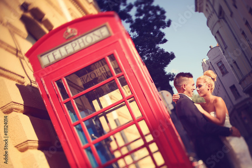 Bride and groom near phonebooth